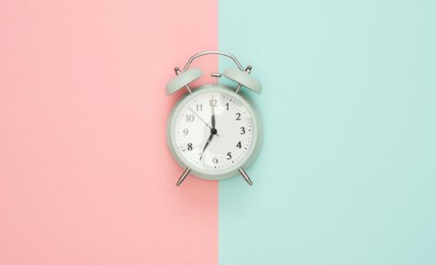 clock on a pink and blue background