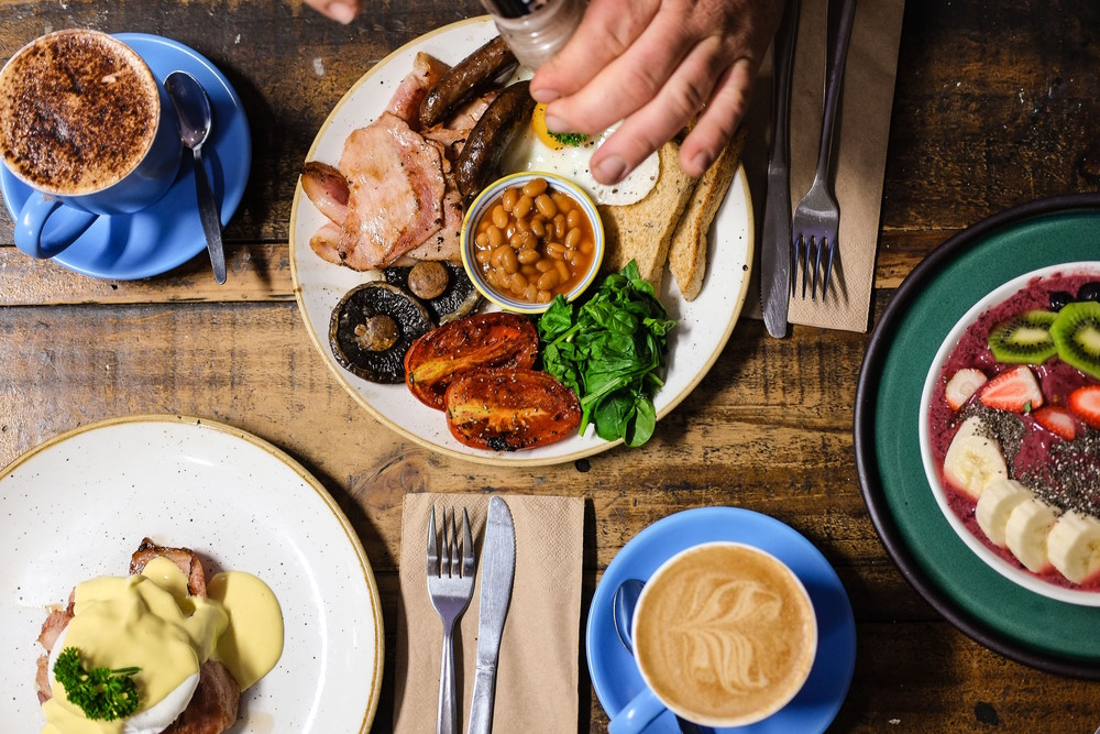 Aerial picture of an array of breakfast foods on a table.