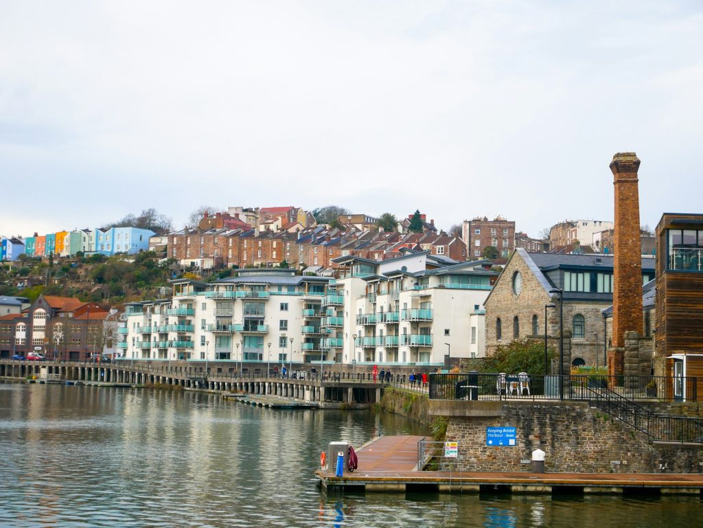 Bristol Floating Harbour with waterside flats and the coloured terraces of Cliftonwood on the hill behind