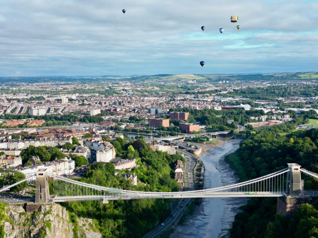 Clifton Suspension Bridge over the Avon Gorge with hot air balloons above Bristol