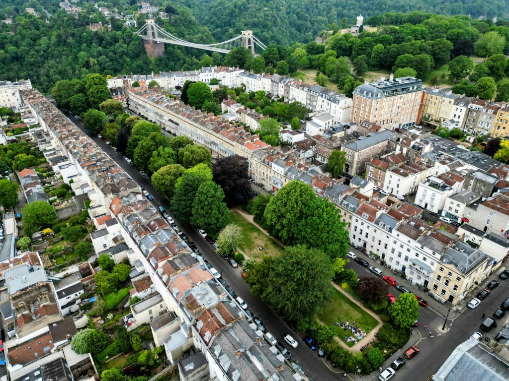 Aerial view of Clifton's Georgian terraces and garden square, with the Clifton Suspension Bridge beyond