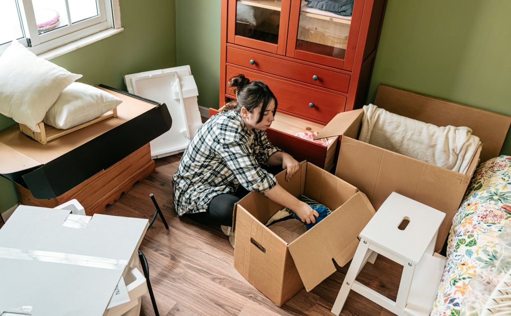 A woman packing cardboard boxes for a move